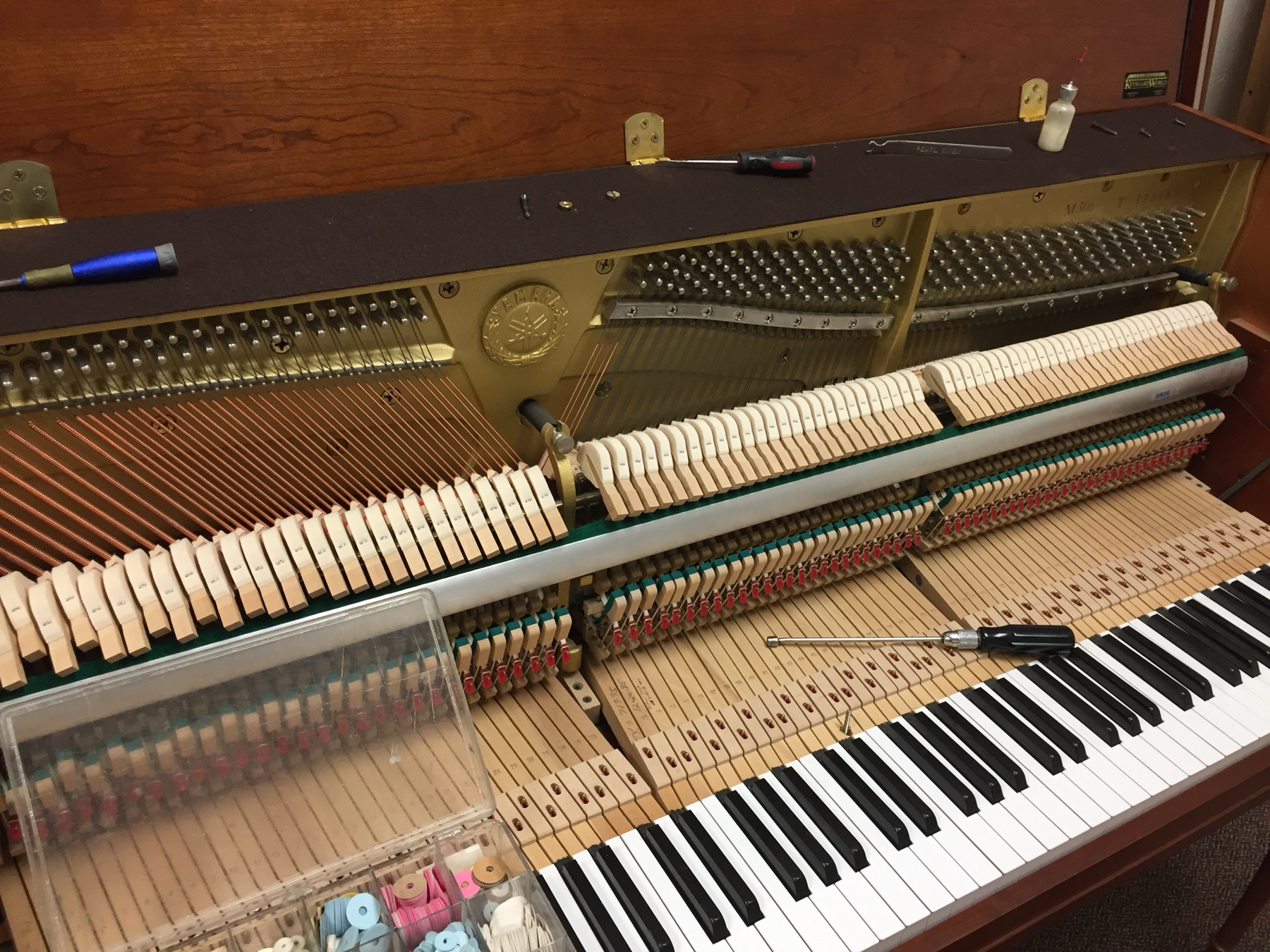 Open upright piano action during service