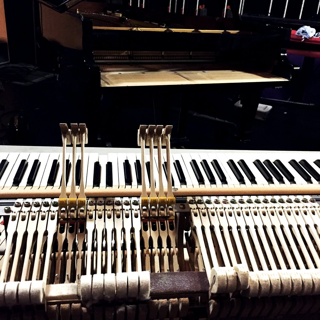 Older grand piano being reconditioned in the workshop