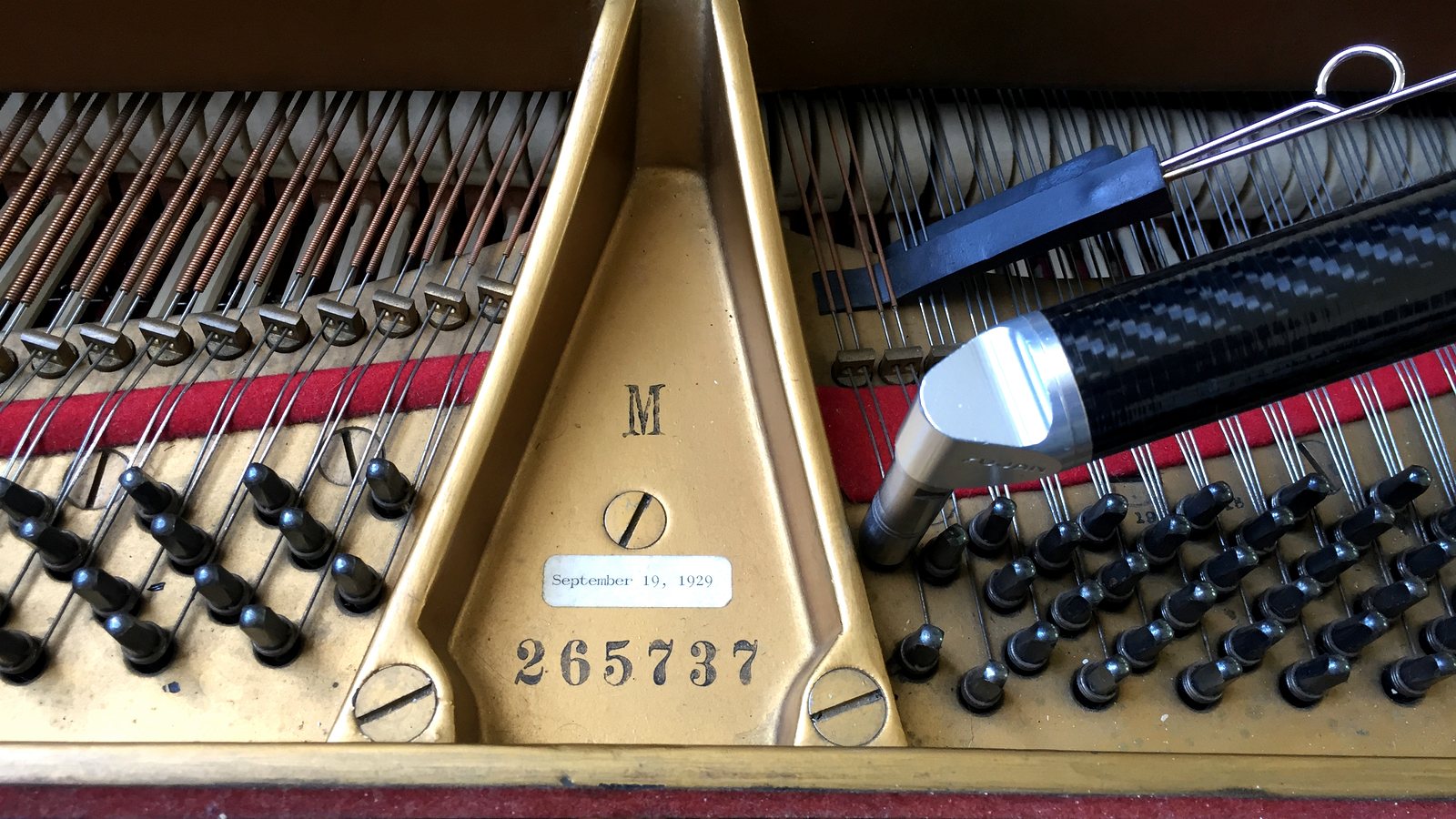 Piano tuning tool inside a grand piano